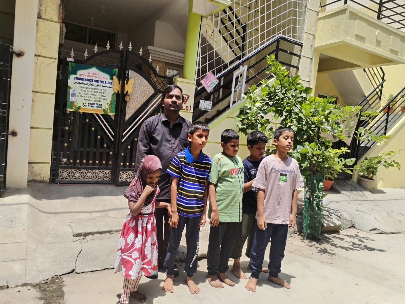 Students and their mentors posing for a photo in front of the trust